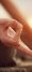 Shot focused on hands of a man doing yoga exercise on the shore